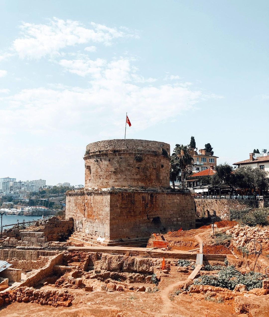The Hıdırlık Tower's fortress surrounded by walls, seamlessly blending with the sea.