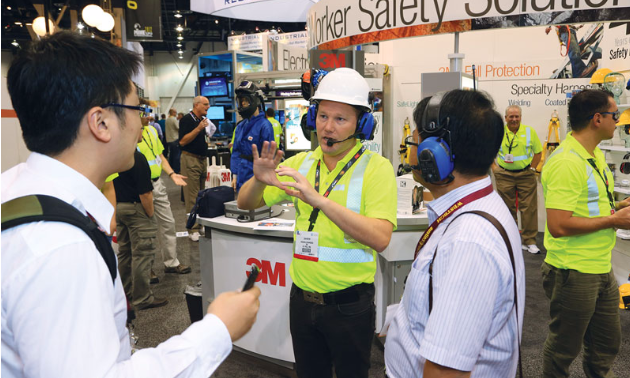 Man at mining expo talking with fellow mining enthusiasts
