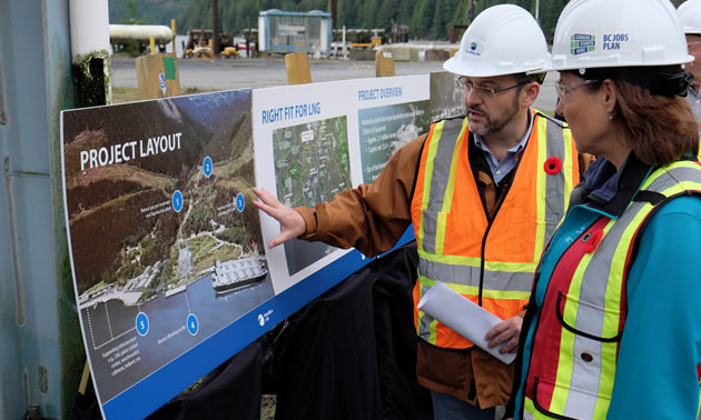 Worker showing BC Premier Christie Clark details about the Woodfibre LNG project.