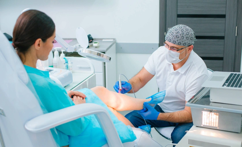 Young female undergoing laser treatment on varicose veins