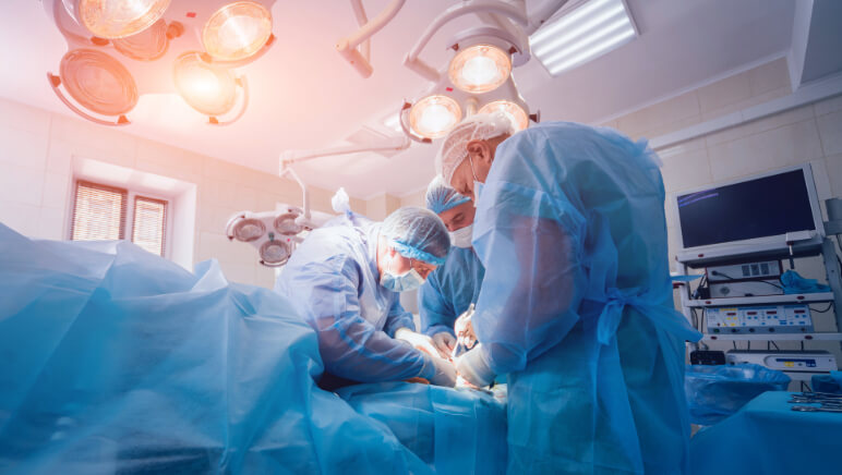 Vein surgeon performing minimally invasive vein surgery on a patient