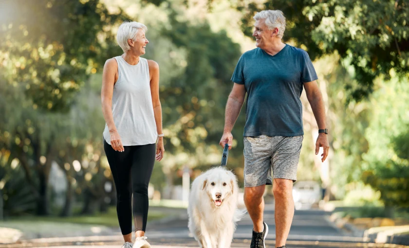 Couple walking outdoors to support circulation and varicose vein health