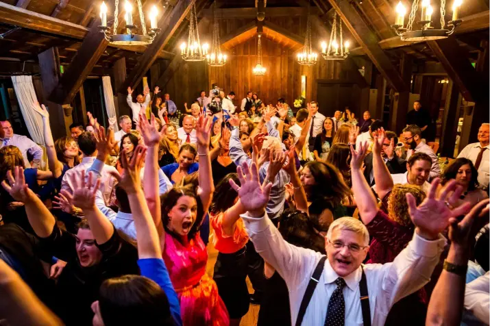 Wedding guests dancing and celebrating on the reception dance floor captured by Portland Event Films
