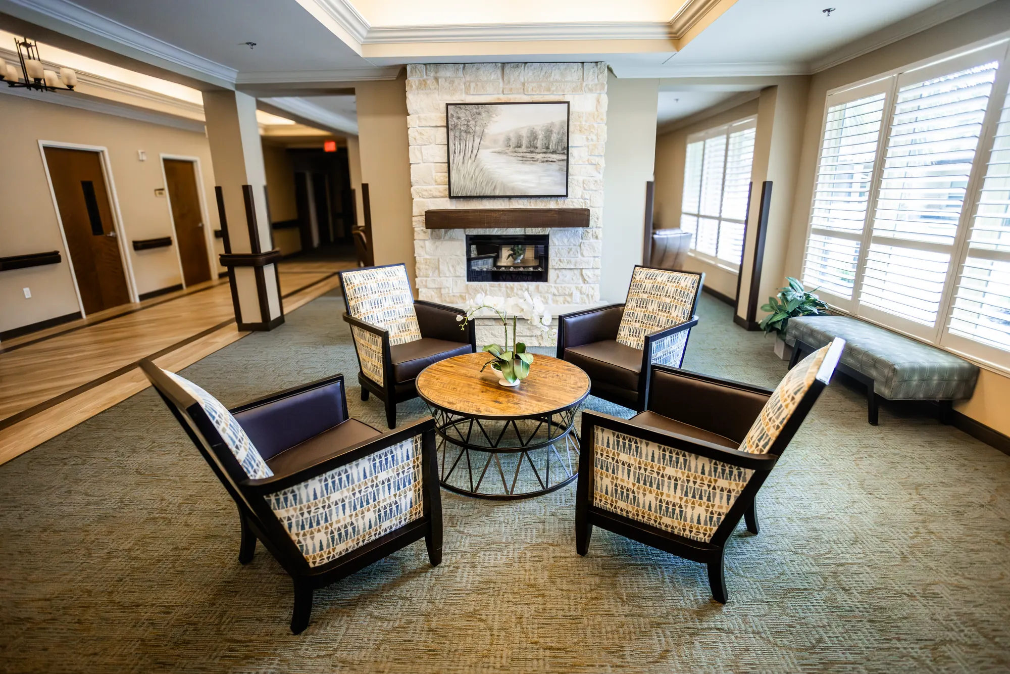 Comfortable fireside lounge with chairs gathered around a table