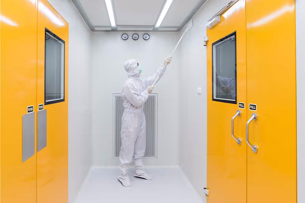 man in insulating suit cleaning deep