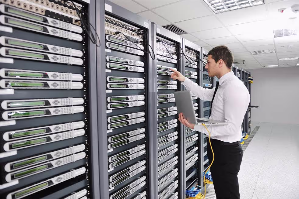 man working with data center machines
