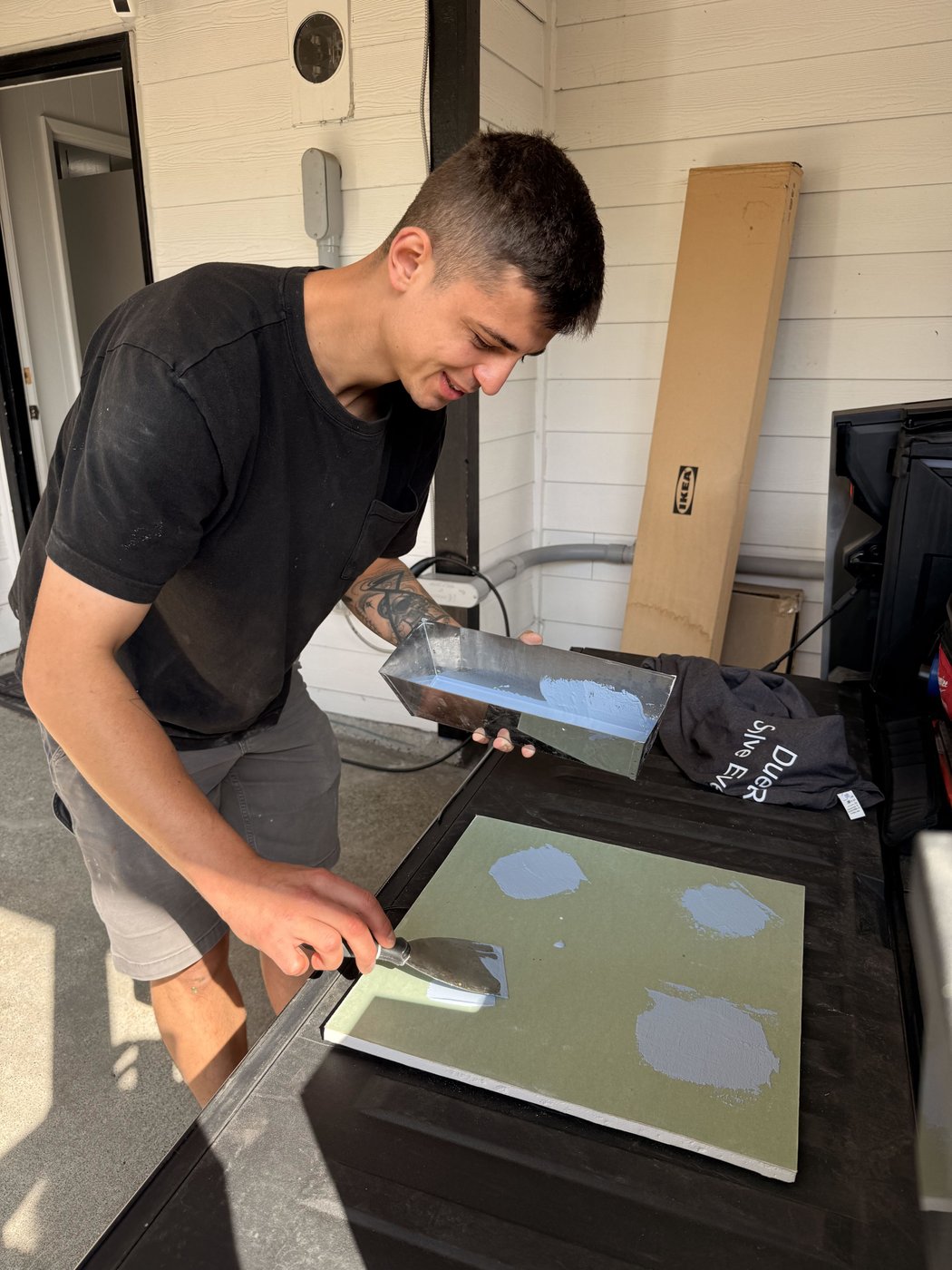 Stan troweling a finish onto a sample board