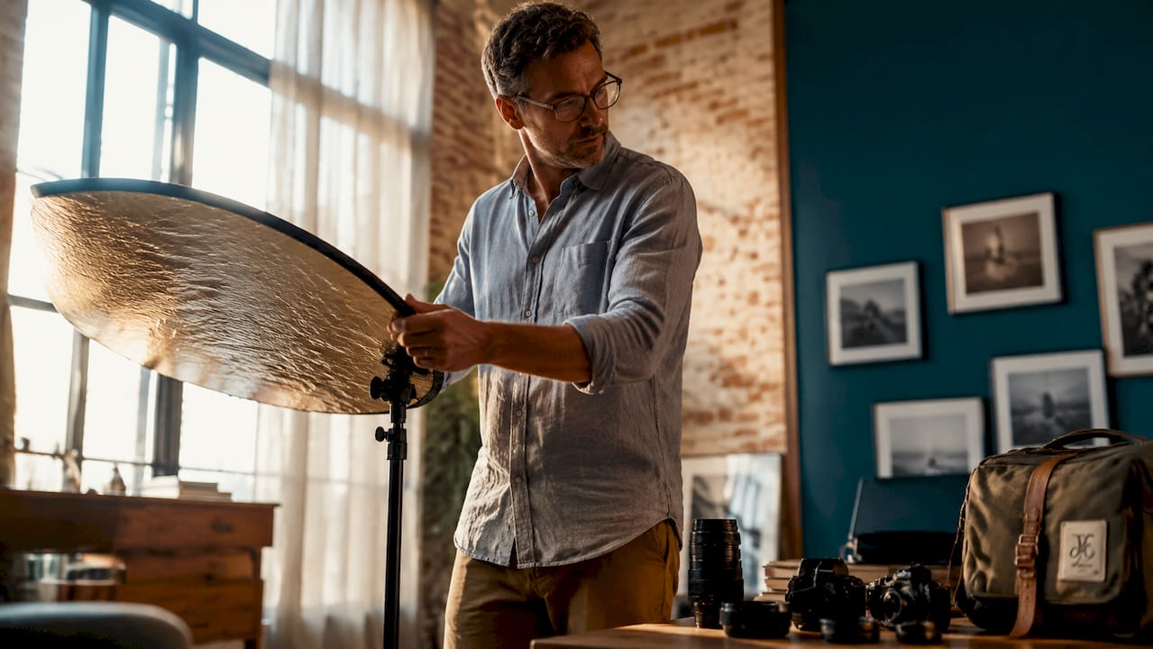 Un photographe peaufine les réglages de ses éclairages en studio pour obtenir l’ambiance parfaite.