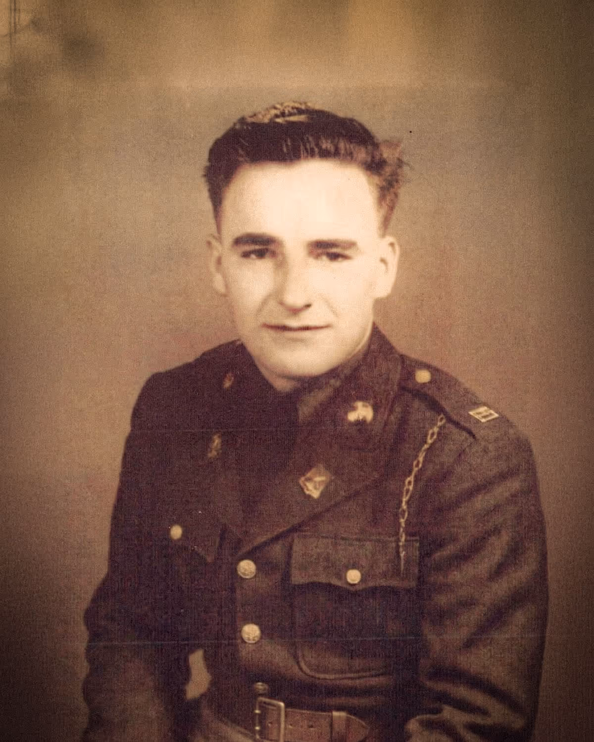 Portrait of a Louis Gresl, Paul Bondar's grandparent, in vintage military uniform with insignia and chain detail on shoulder.