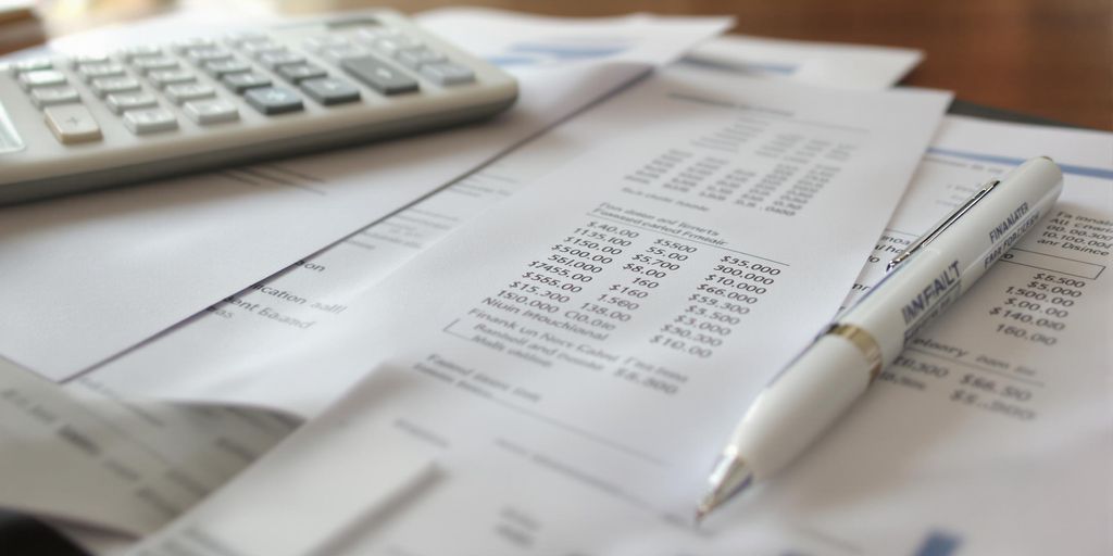 Business desk with financial documents and calculator