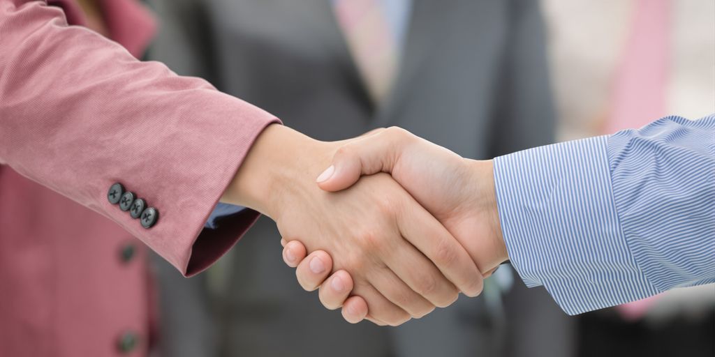 A person shaking hands with another person.