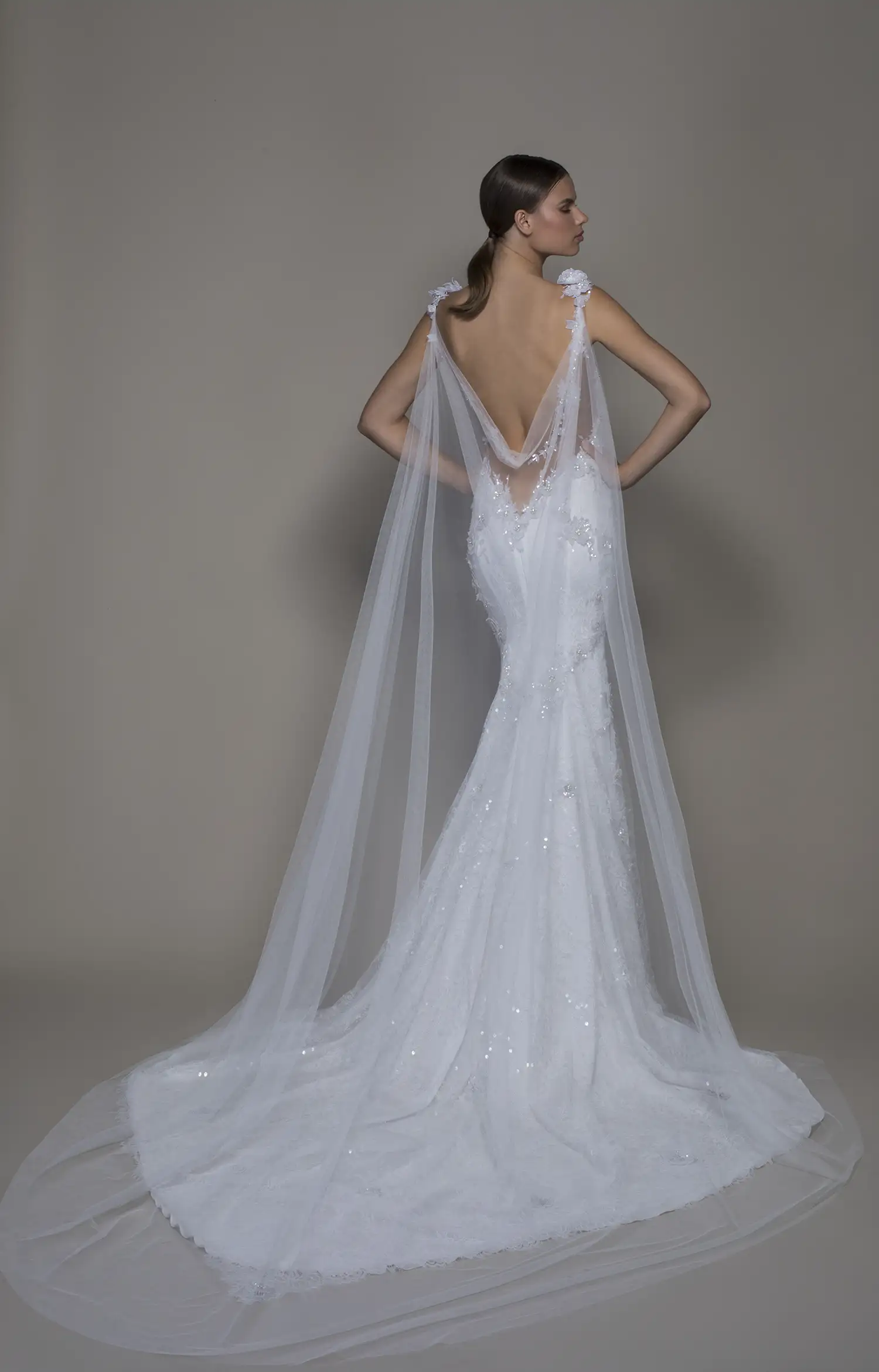 Lace sheath gown with dimensional silver sequin floral applique and detachable draped soft tulle cape