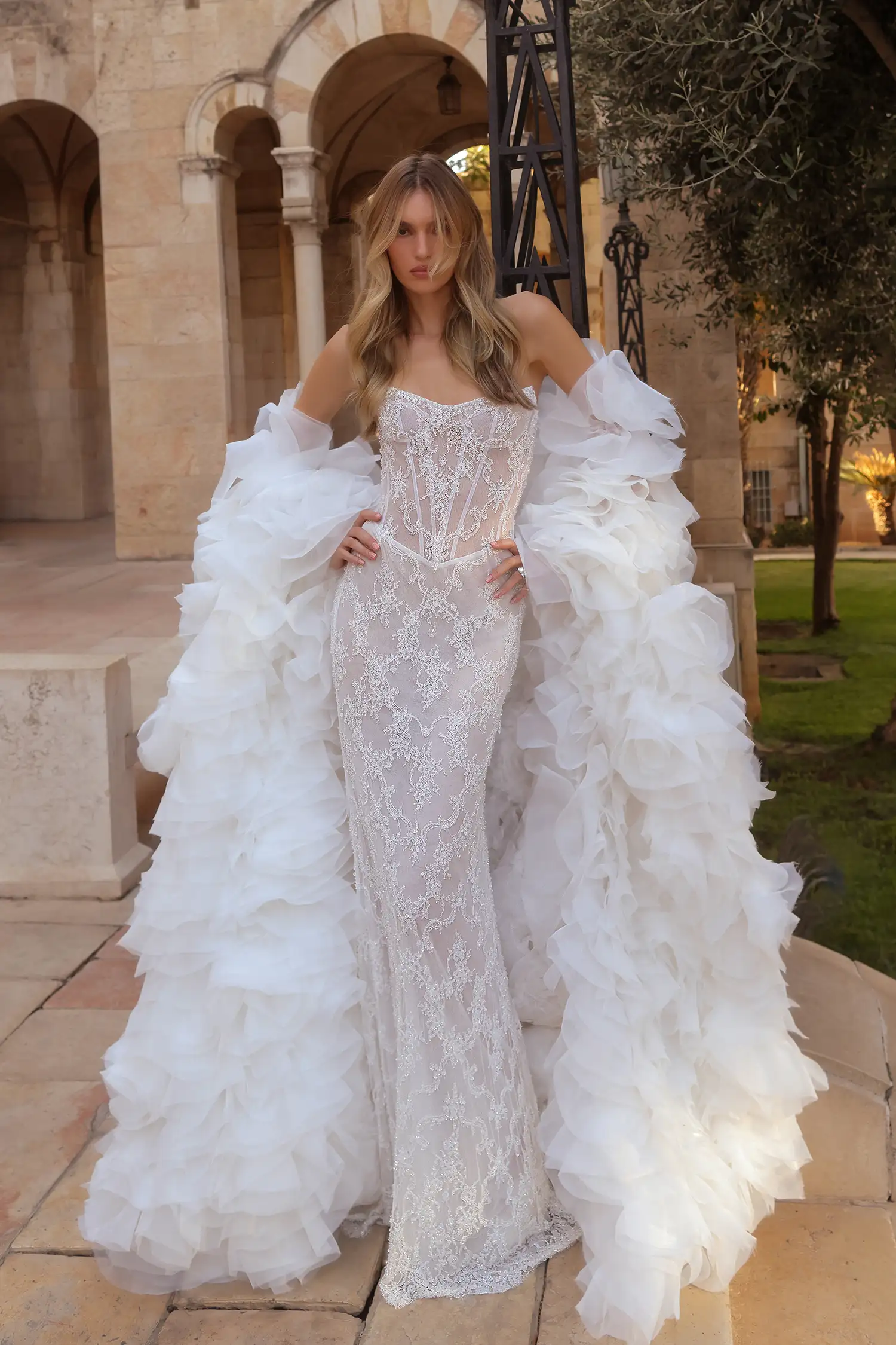 Strapless chantilly lace sheath gown fully hand beaded in water crystals with hanging water crystal droplets. Shown with handmade organza flower stole.
