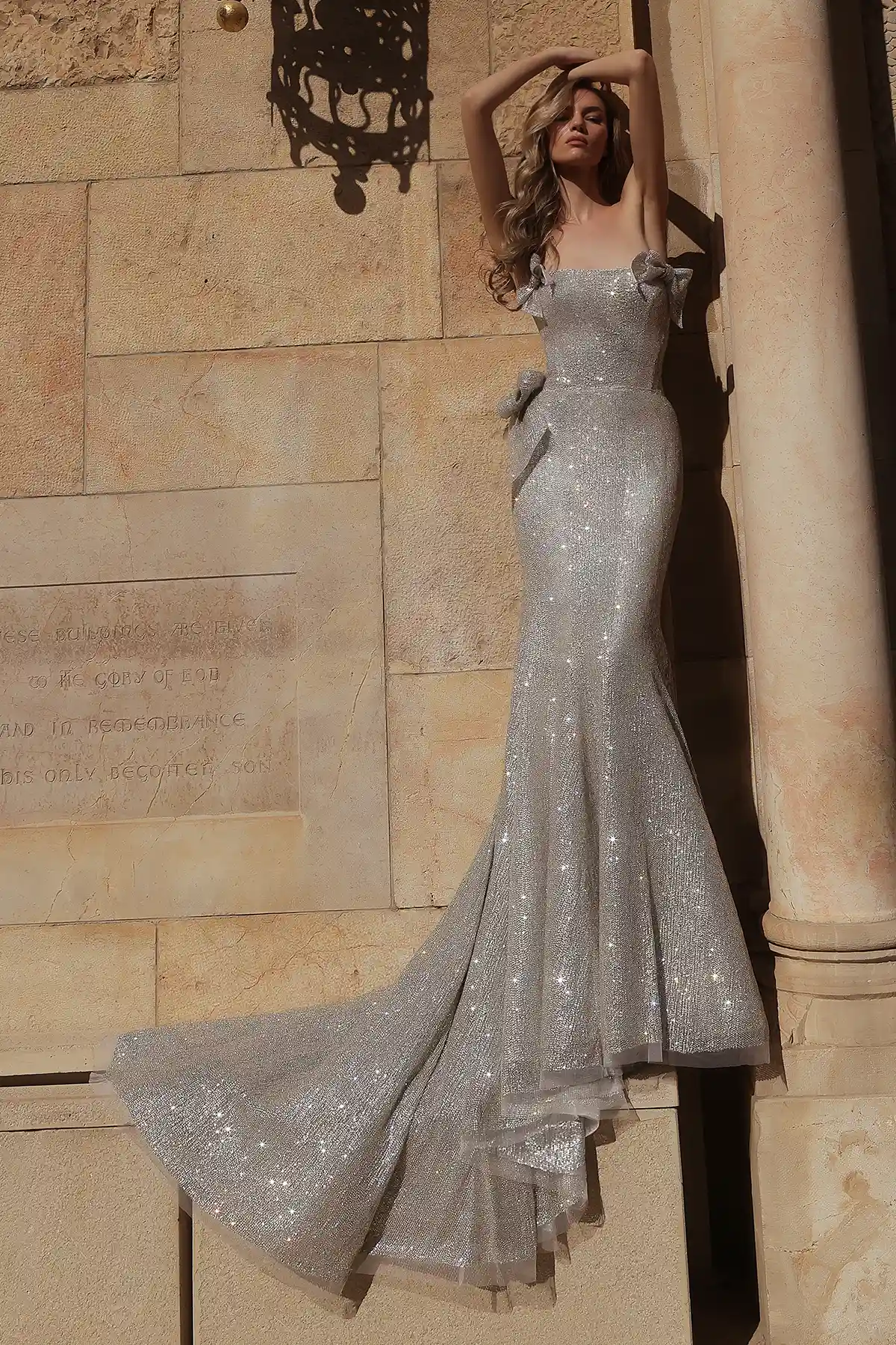 Strapless, straight-neckline fit-and-flare gown fully hand-beaded in silver crystals with silver crystal bow details.