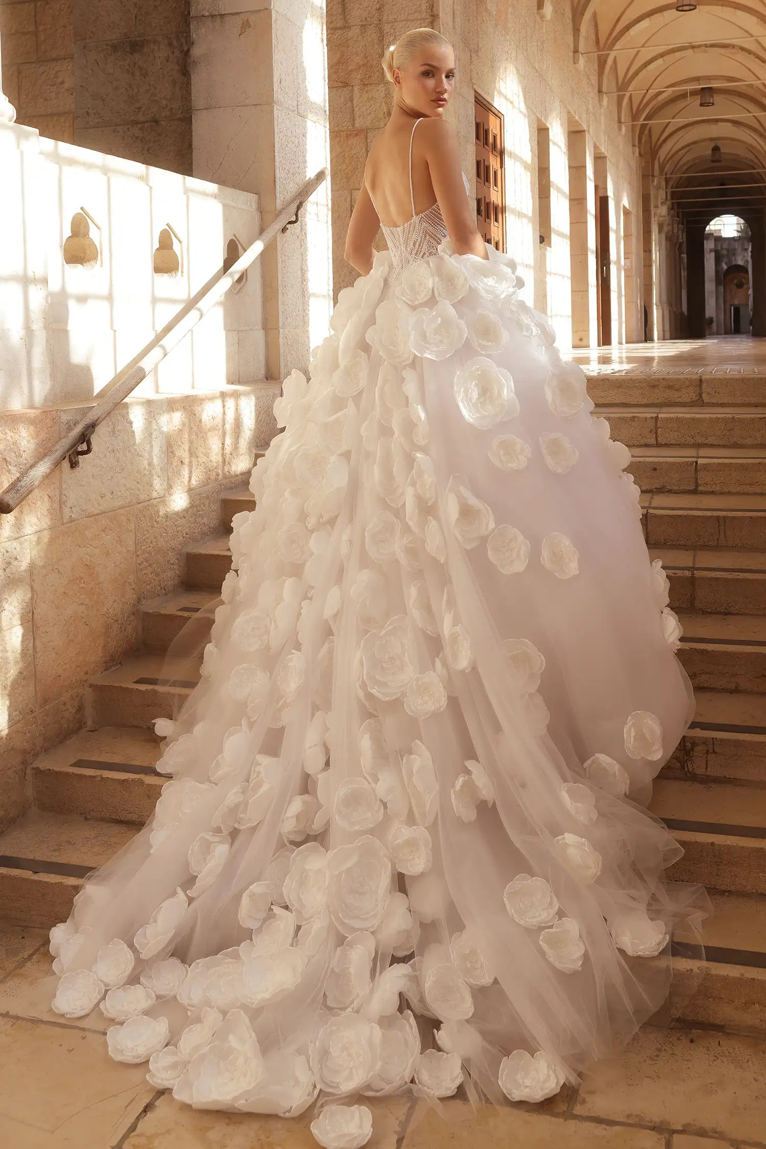 Ballgown with hand-beaded pearl bodice, satin dimensional flower skirt with pearl details, and pearl off-the-shoulder straps.
