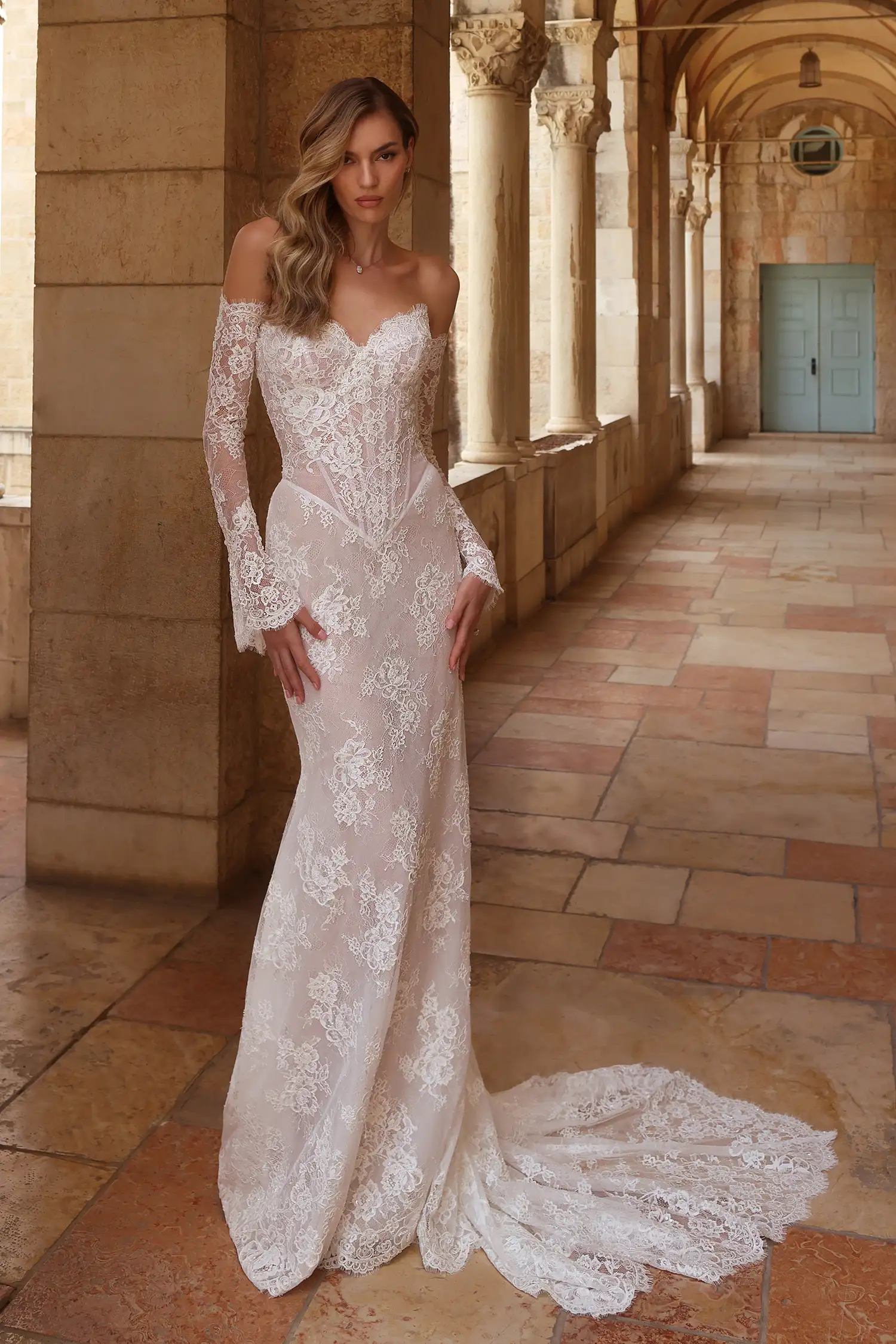 Beaded alençon lace strapless fit-and-flare gown with sweetheart neckline, pointed basque waist, and beaded lace gauntlet gloves.