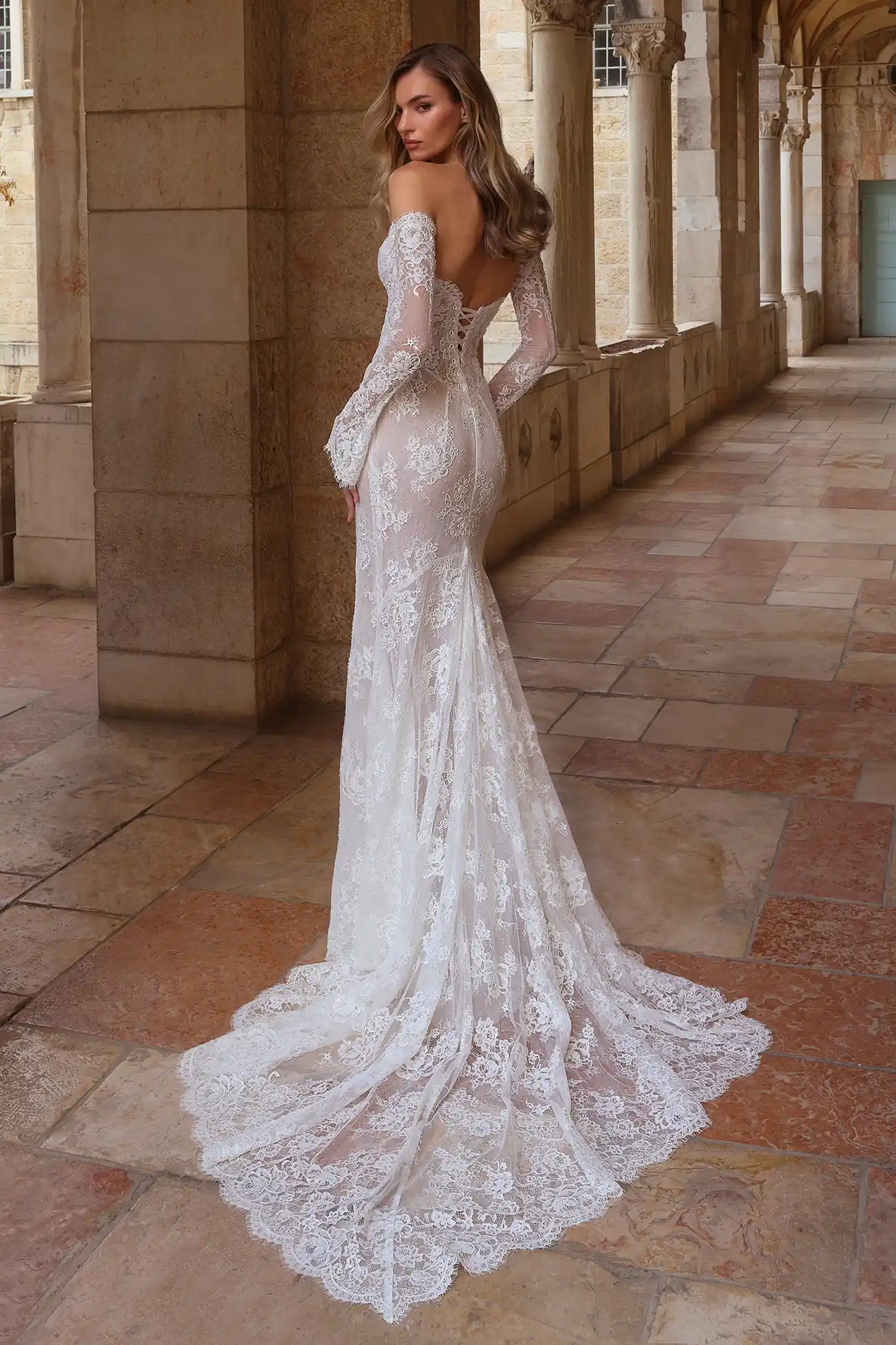 Beaded alençon lace strapless fit-and-flare gown with sweetheart neckline, pointed basque waist, and beaded lace gauntlet gloves.