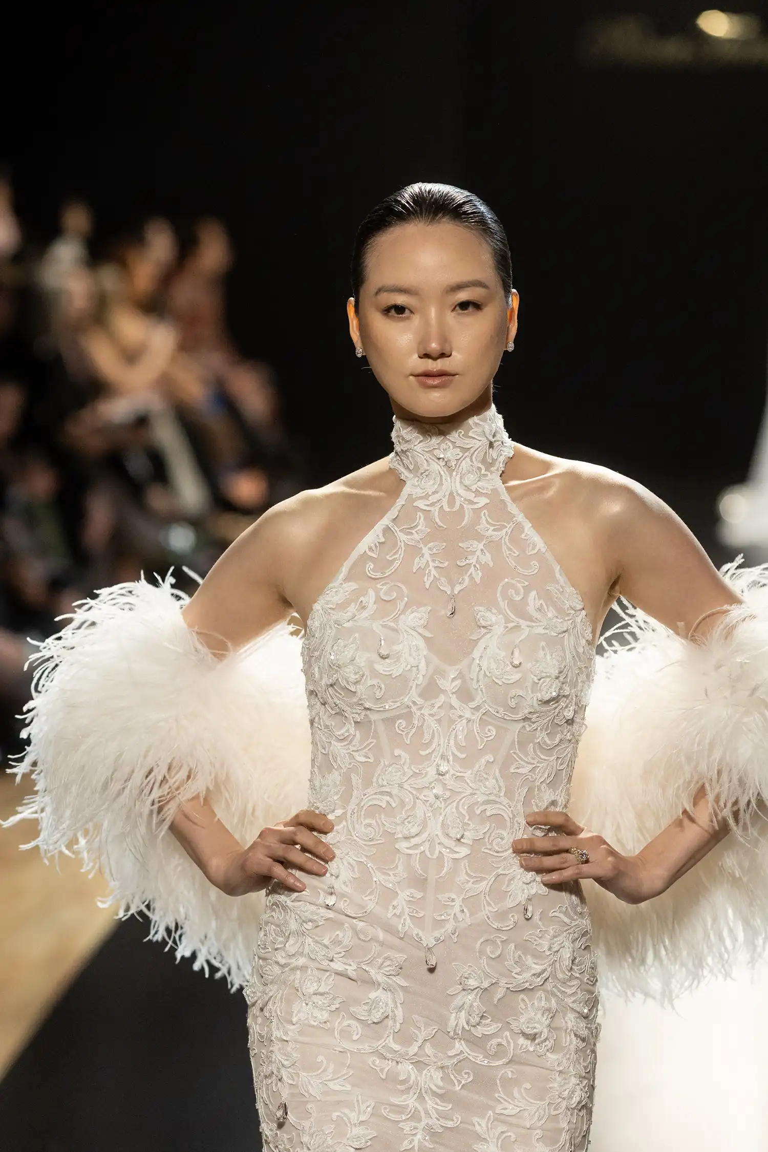 Halter sheath gown in beaded, dimensional flower embroidered boroque lace with hanging water crystal droplets. Shown with ostrich feather stole.