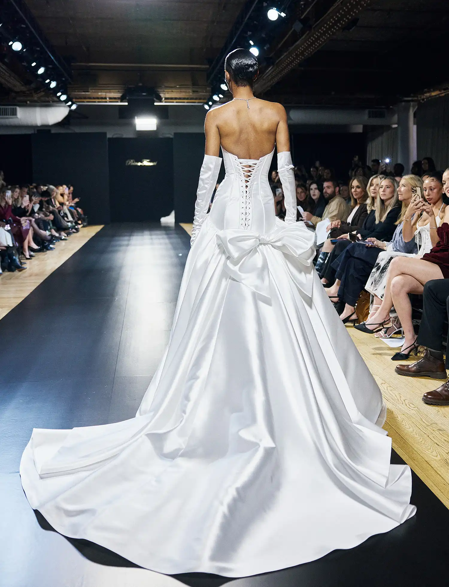 Mikado ballgown with strapless sweetheart drop-waist bodice, corset back, and signature Pnina bow.