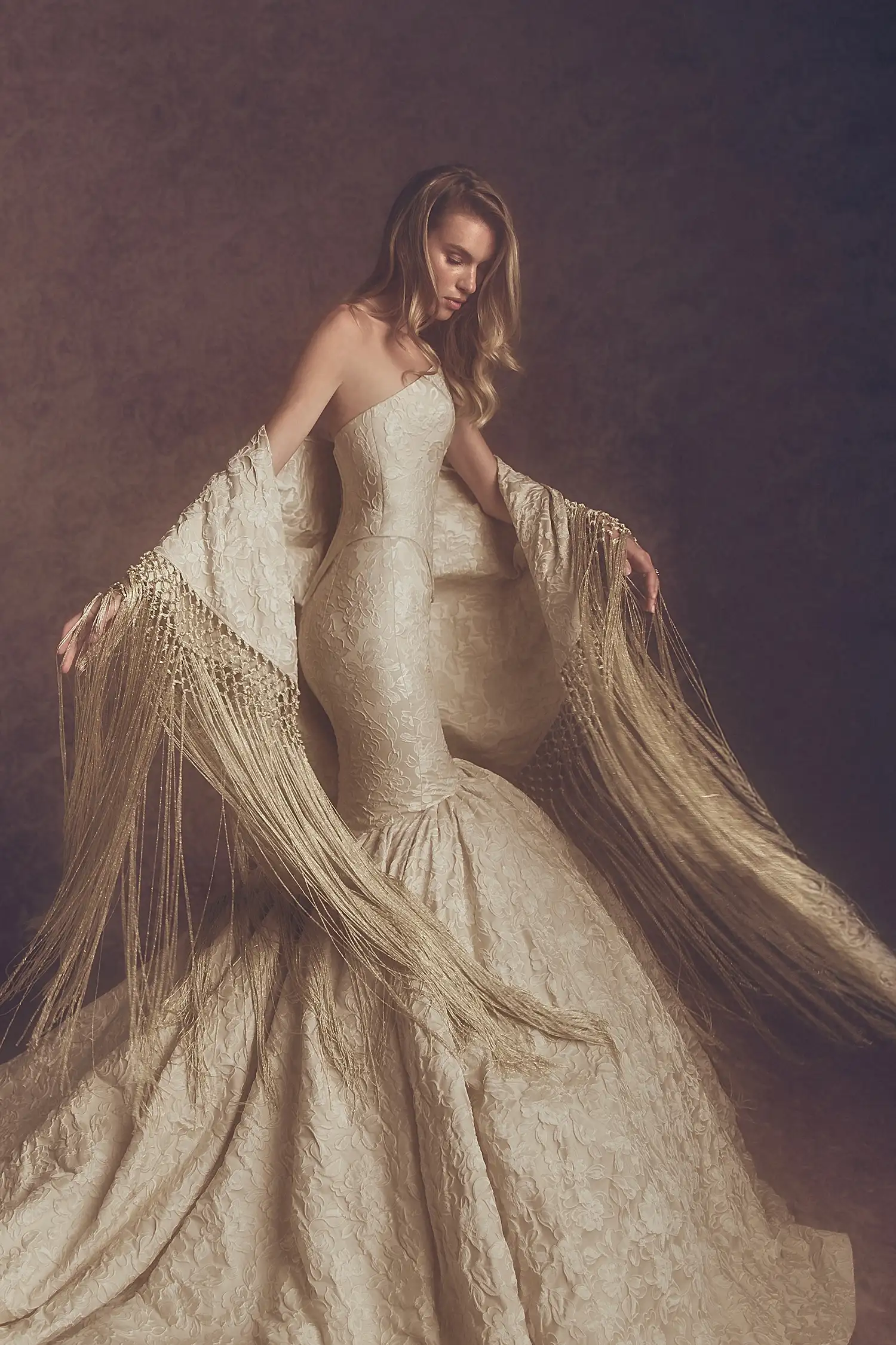 Crescent neckline strapless mermaid gown in caramel floral cloqué, shown with matching fringe shawl.