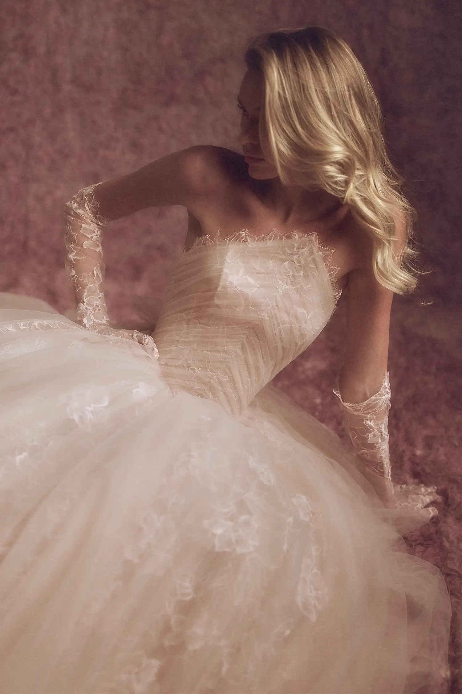 Blush chantilly lace and tulle ballgown with basque waist, inverted V neckline, and hand-beaded feather butterflies. Shown with matching chantilly lace gloves.