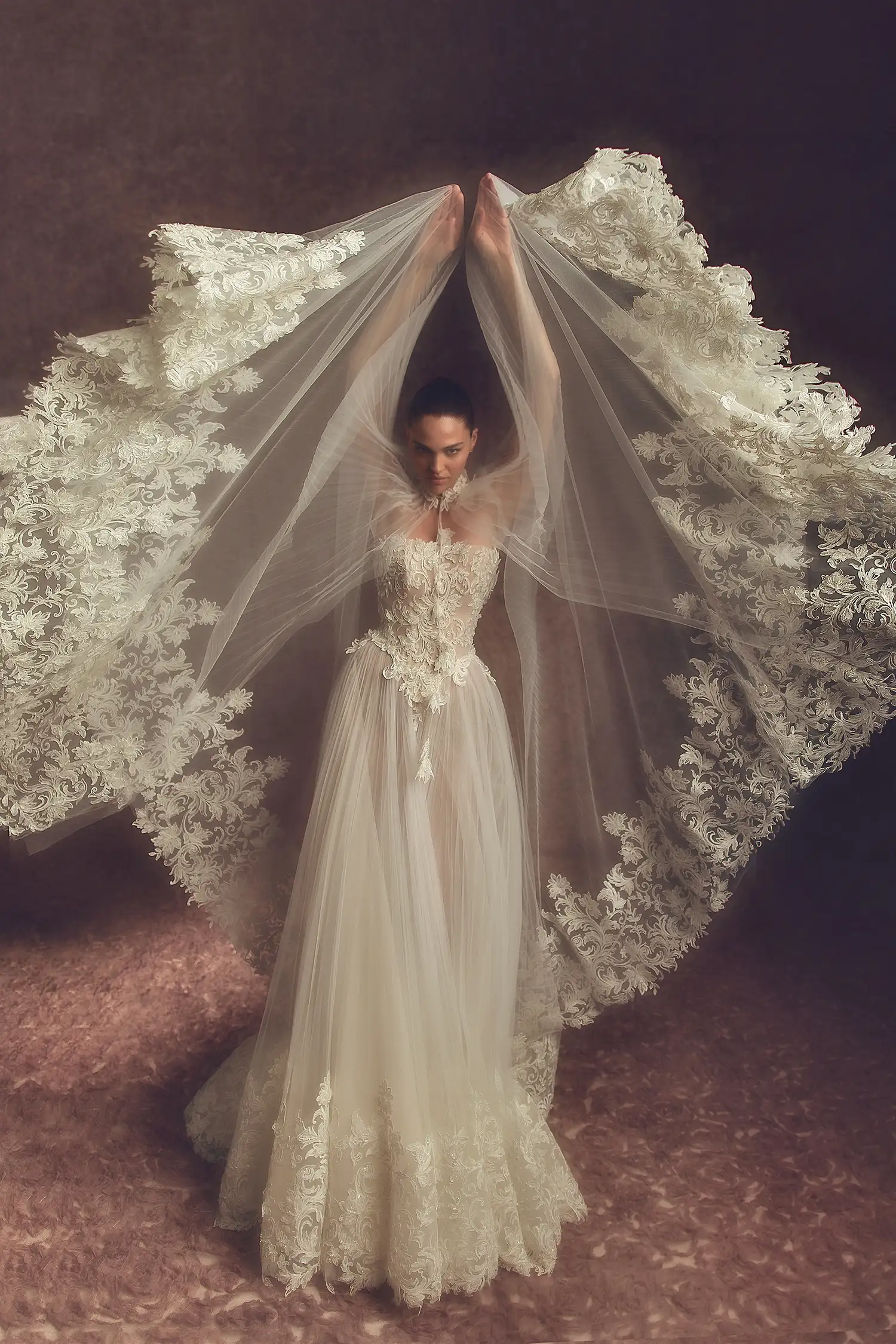 Strapless beaded lace and sunray pleated tulle A-line gown with matching sunray pleated tulle and beaded lace appliqué cape.