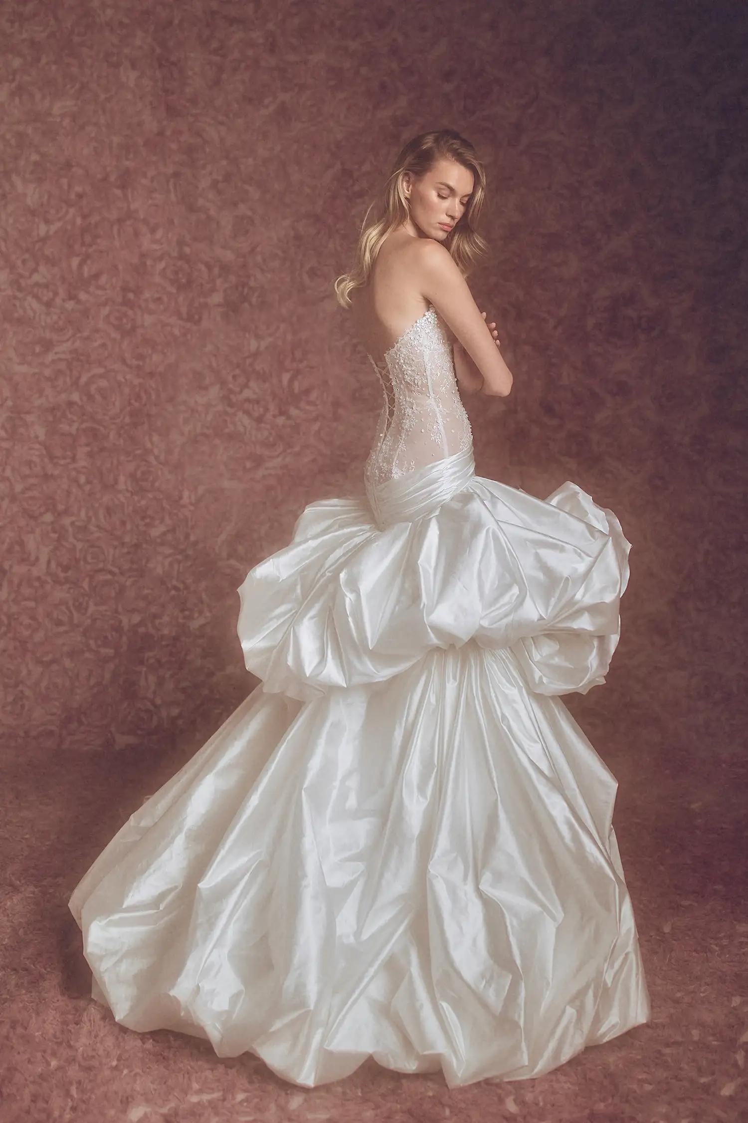Strapless sweetheart neckline drop waist ballgown in hand-beaded chantilly lace and pearl silk taffeta, with pickups and oversized handmade roses.