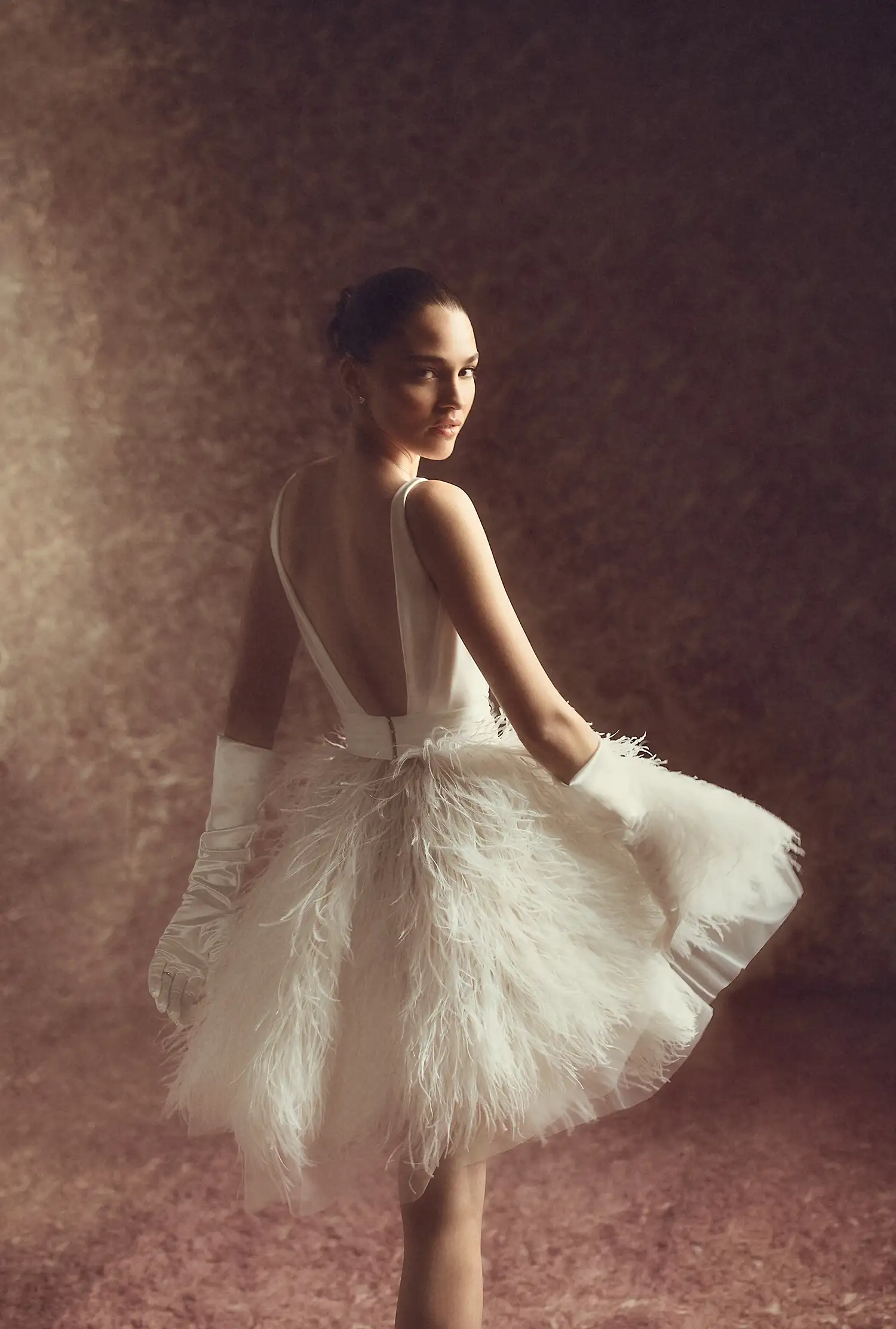 Deep V neckline minidress with ostrich feather A-line skirt and draped satin bodice.