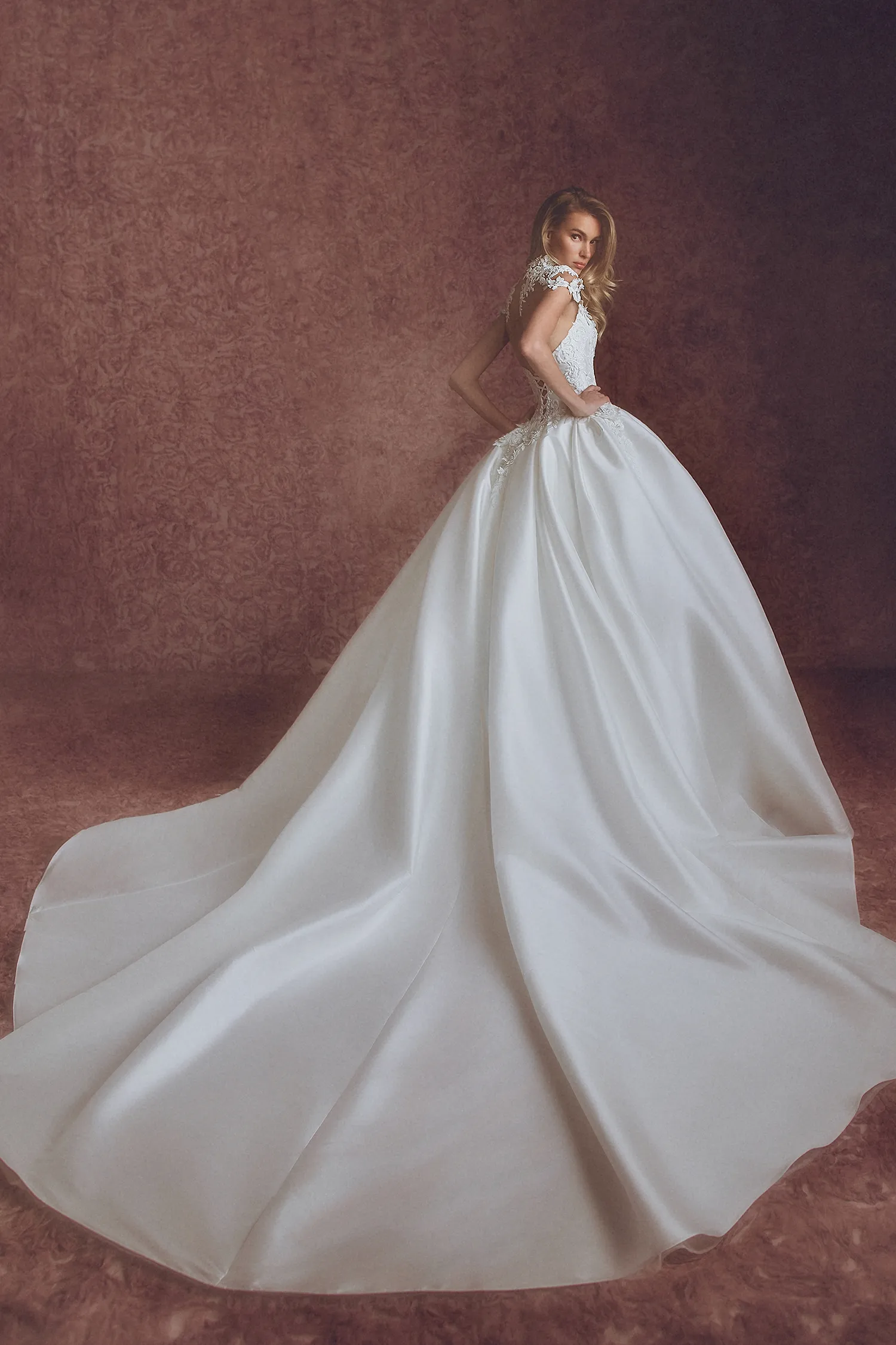 Strapless taffeta ballgown with hand-beaded dimensional floral appliqué bodice, shown with matching illustion appliqué bodysuit and hand-beaded lace mantilla veil.