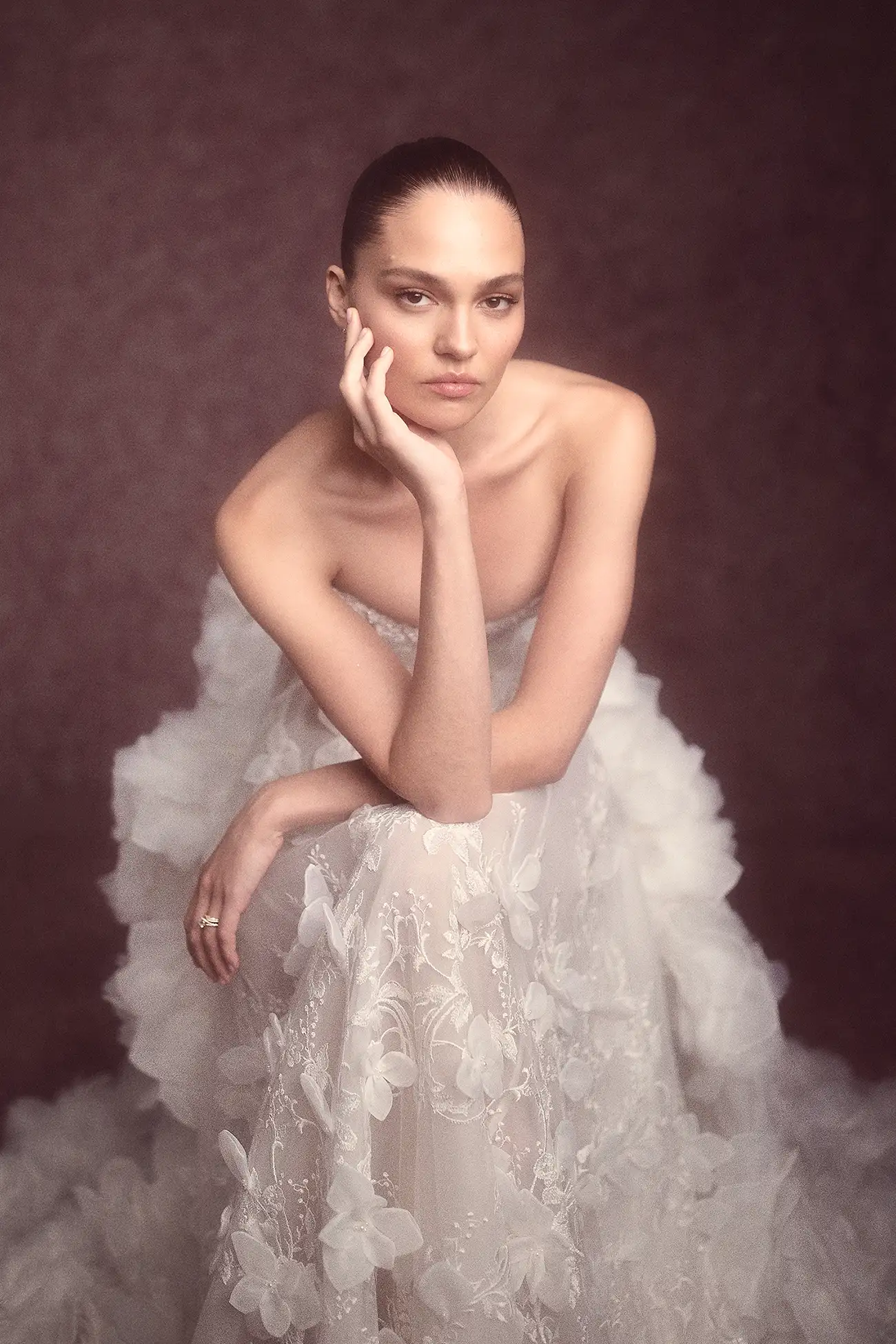 Strapless V neckline embroidered and beaded lace A-line gown with organza petals, shown with matching dimensional organza flower cape.