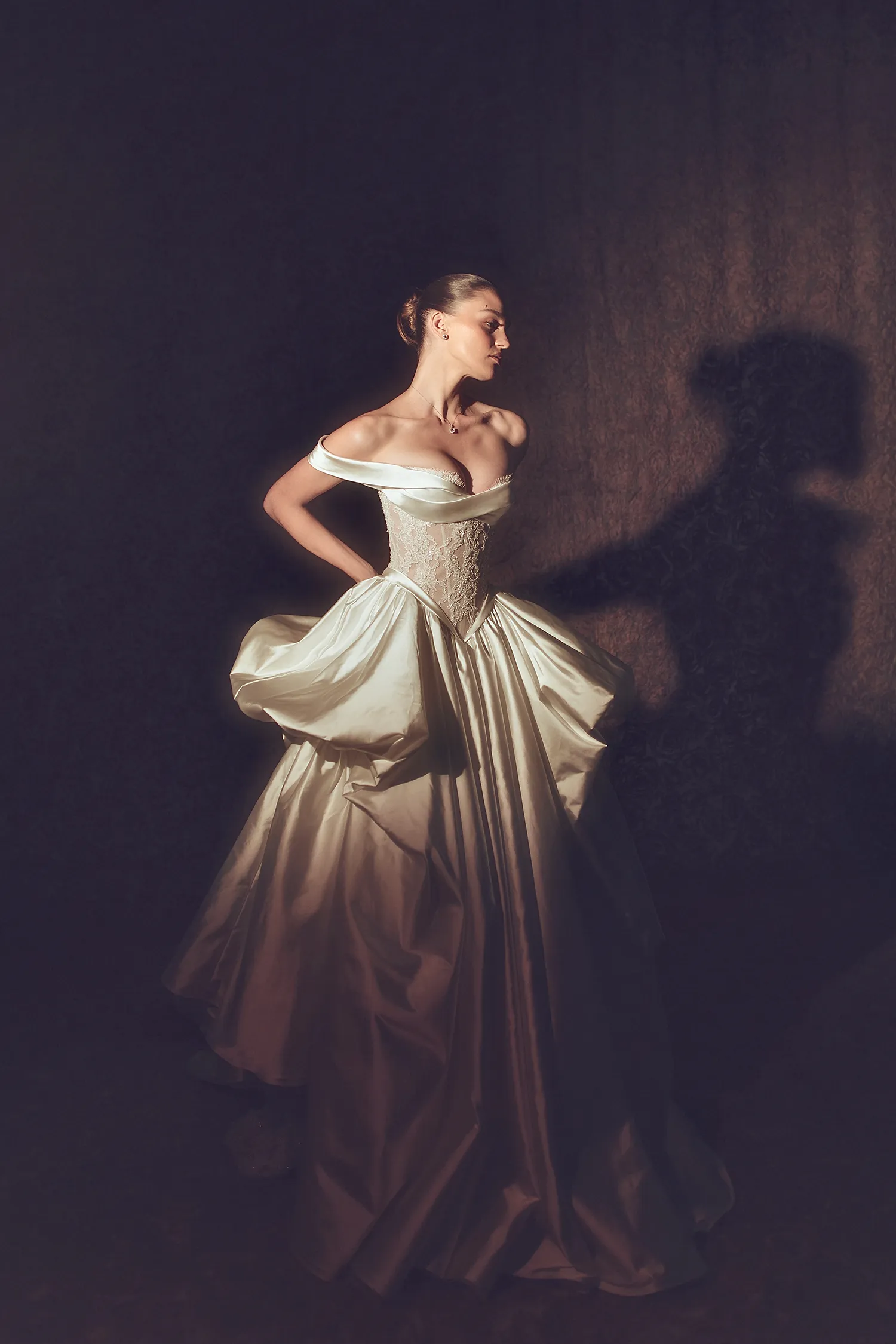 Silk satin gown with hand-beaded Alençon lace bodice, skirt pickups, dimensional flowers and signature Pnina bow.