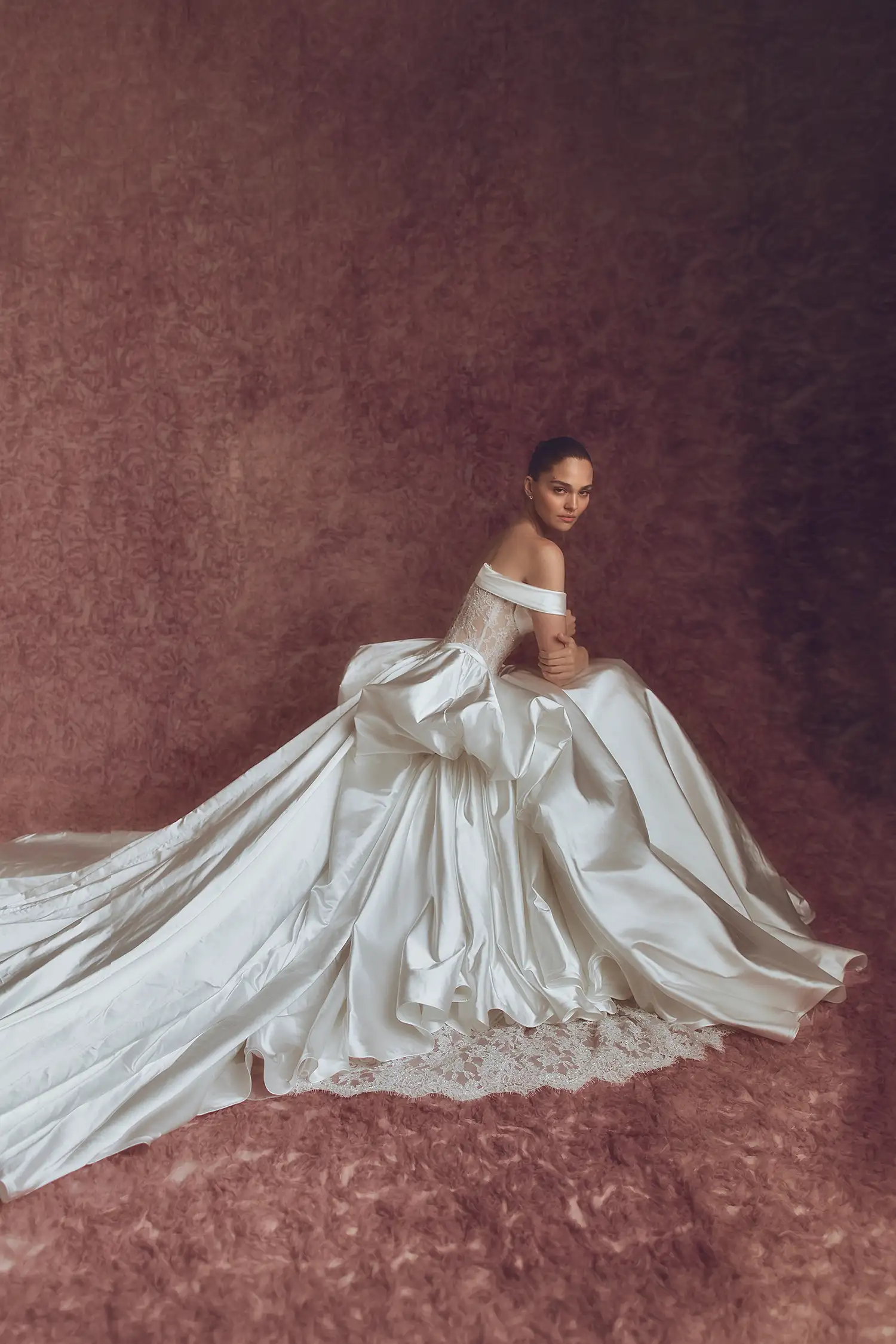Silk satin gown with hand-beaded Alençon lace bodice, skirt pickups, dimensional flowers and signature Pnina bow.