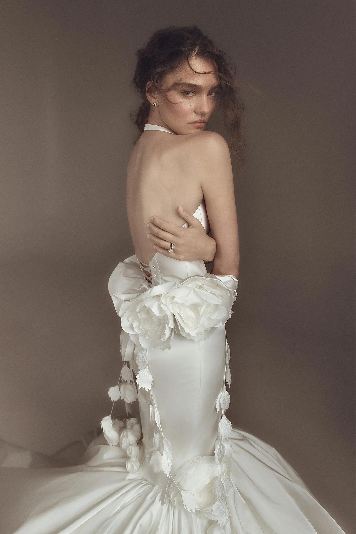 Satin mermaid gown with scoop neck halter corset, ruffled basque, and dimensional rose and hanging vine details.