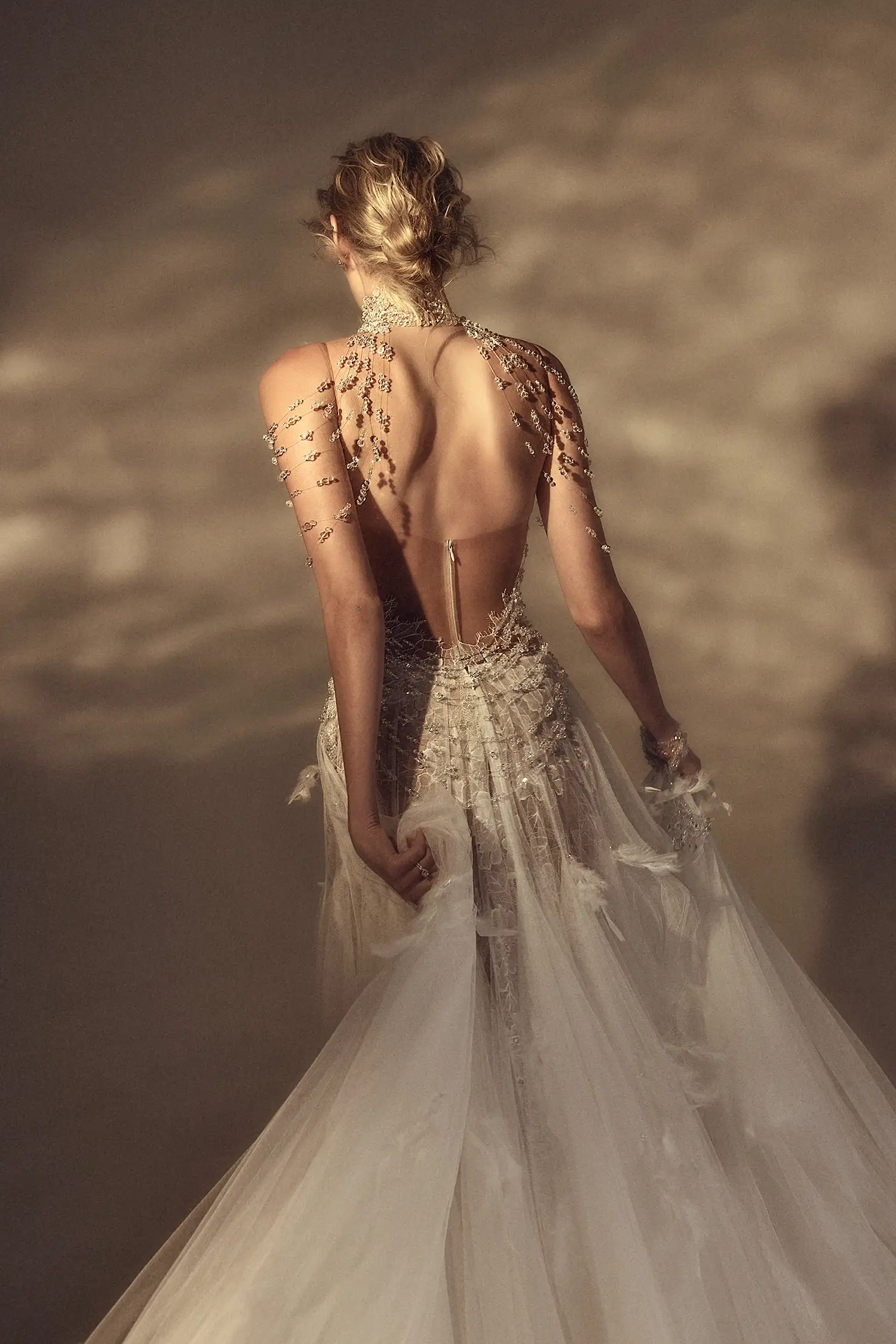 Chantilly lace and soft tulle godet gown draped in clear crystals, with matching clear crystal neck and shoulder piece.