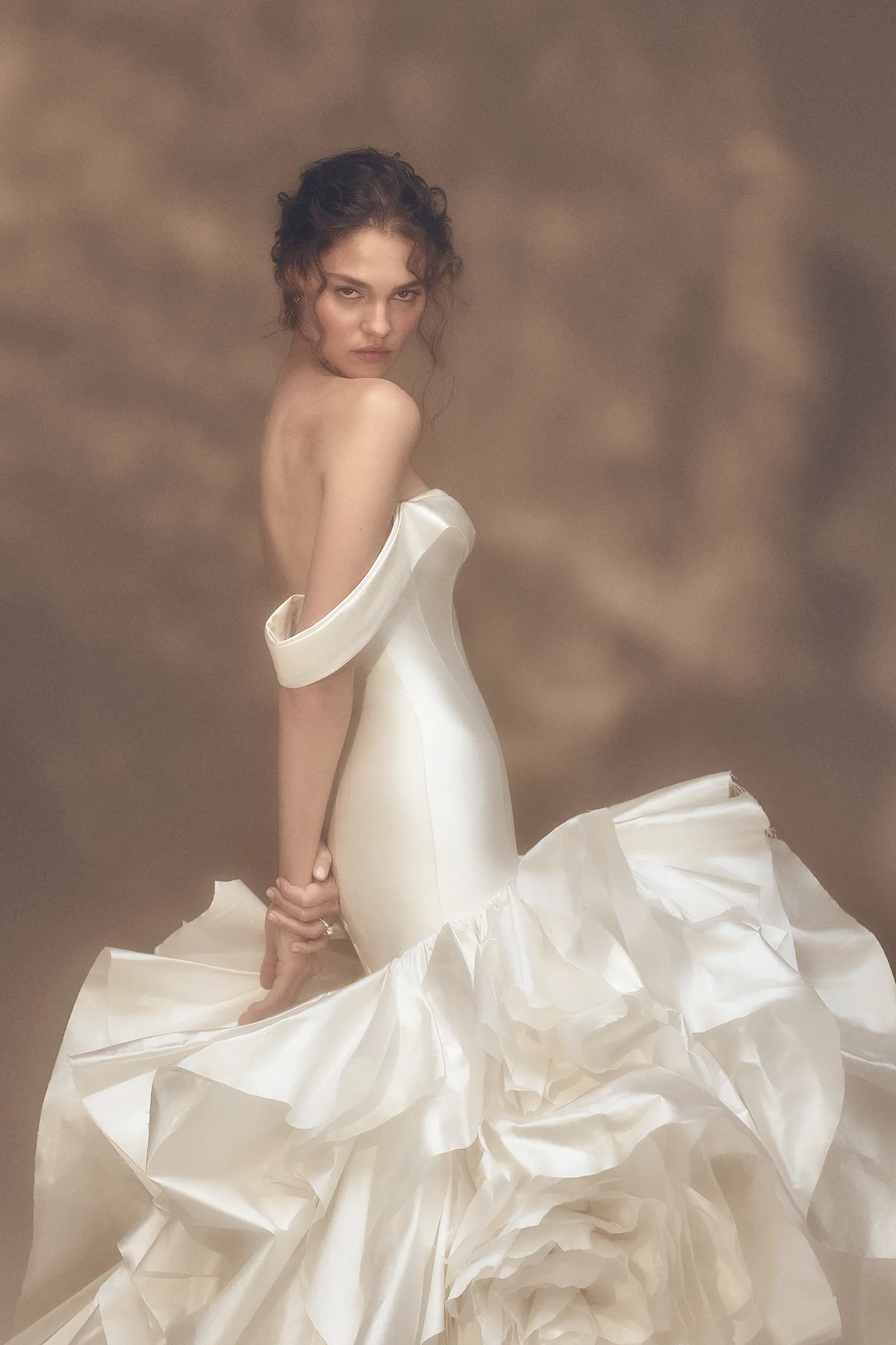 Off-the-shoulder sweetheart drop waist gown in pearl taffeta with dramatic ruffle and handmade rose skirt.