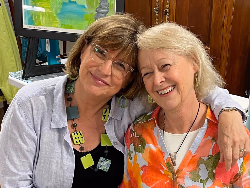 Two Rolling Ridge retreat leaders smile together during a Rolling Ridge workshop