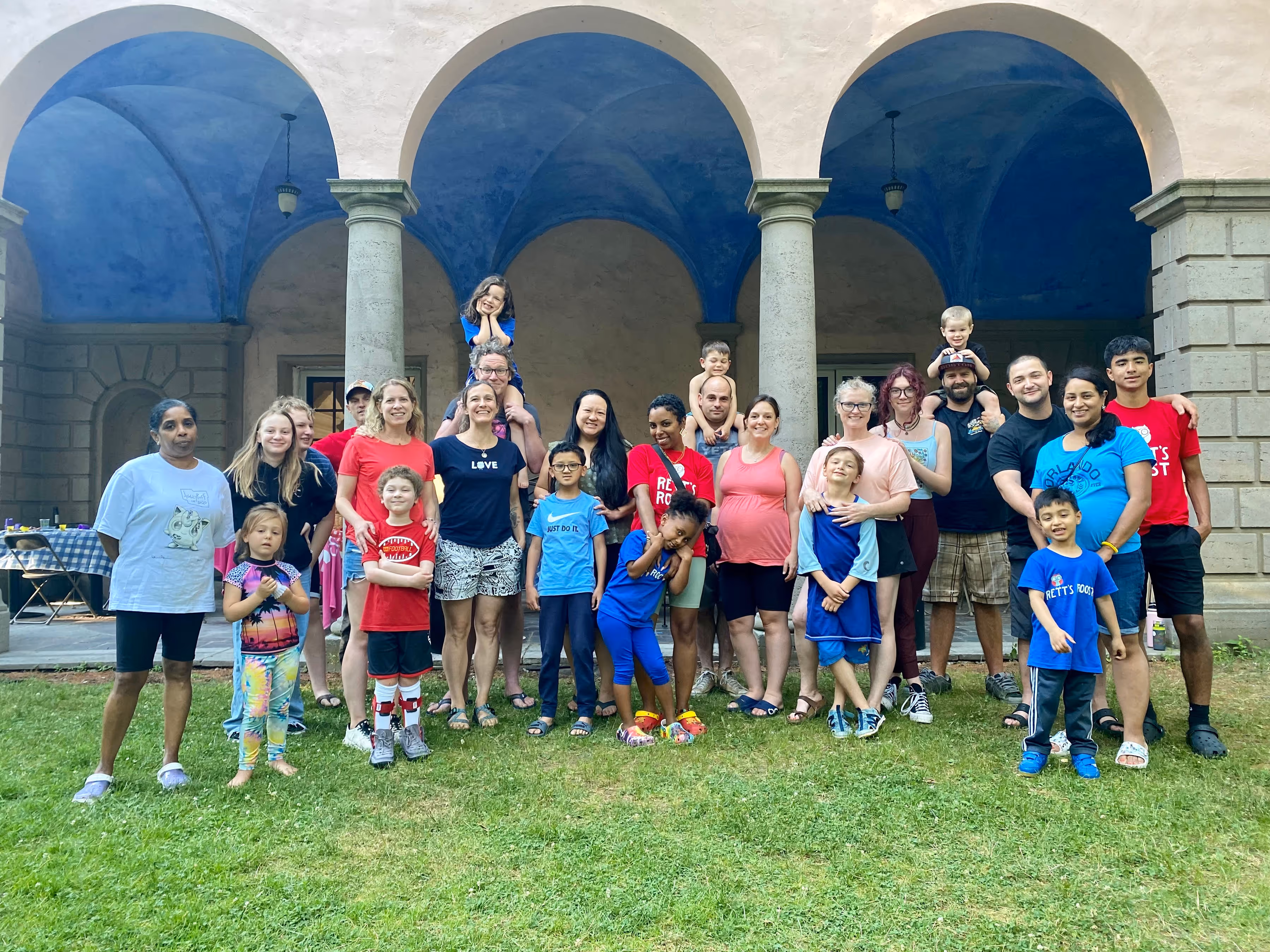 A photo of a group of retreat participants in front of the Tyson Hall patio, with column in the background