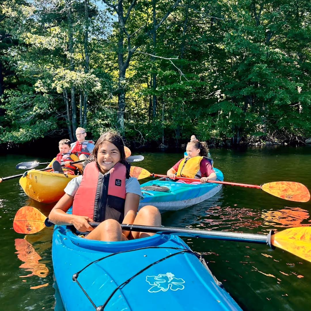 A photo of kayakers on Lake Cochichewick during a retreat at Rolling Ridge