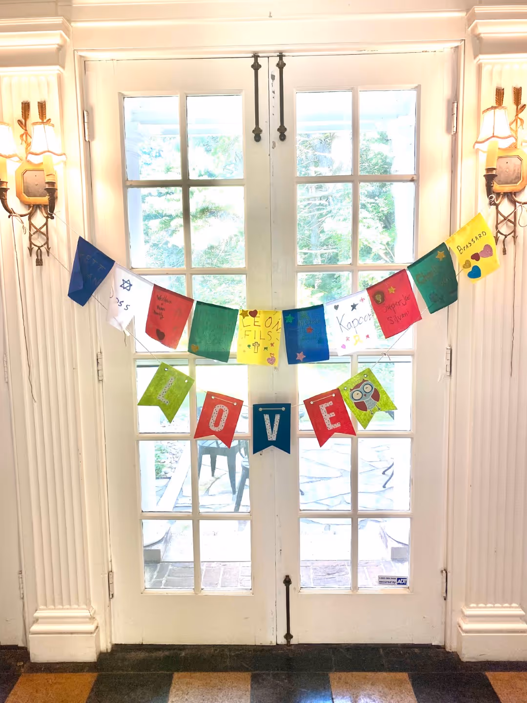Colored flags over Rolling Ridge doors in Tyson Hall