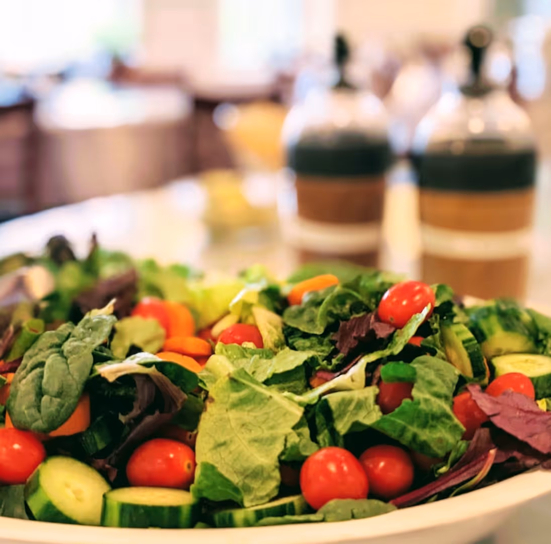 An image of a hummus, feta, and tomato salad, prepared by chefs at Rolling Ridge