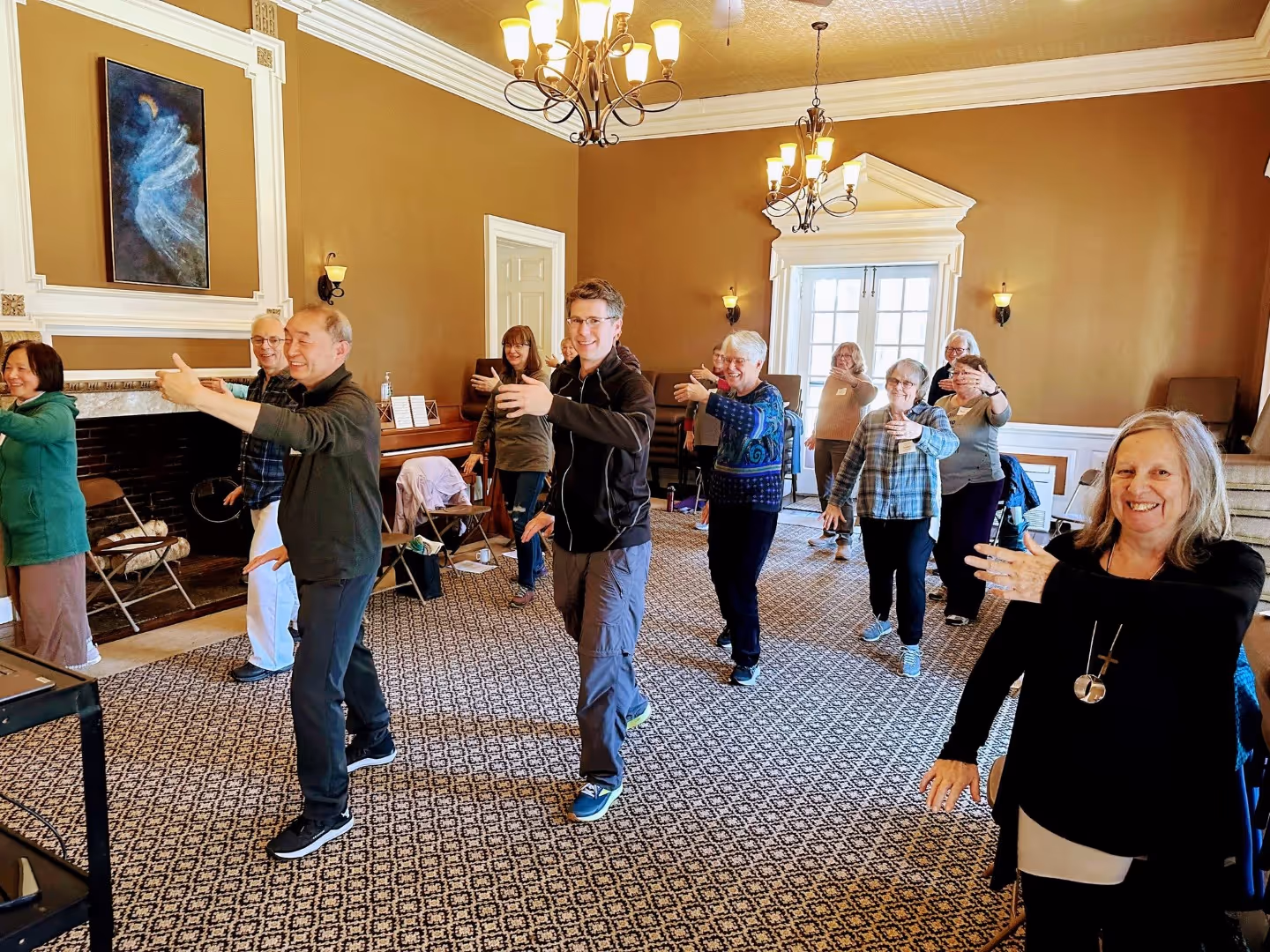 A group of Tai Chi participants practice in Tyson Hall