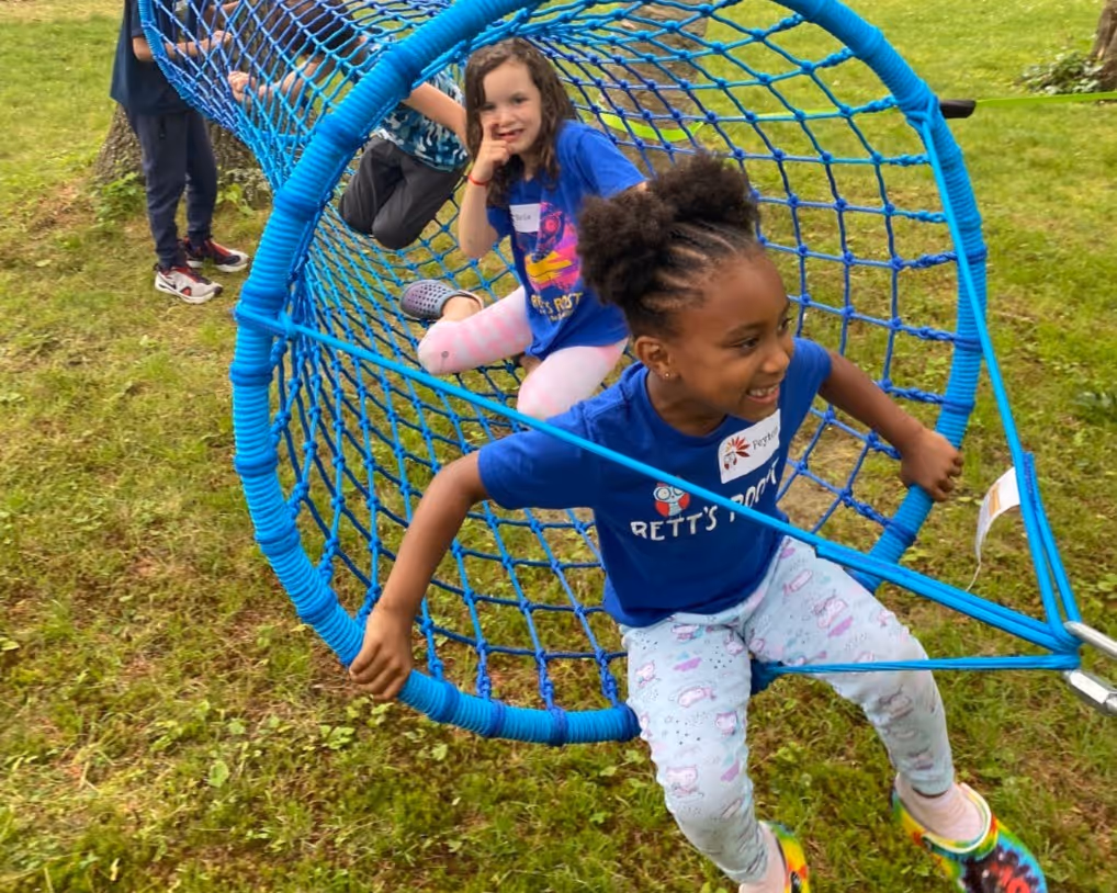 A child moves through a rope tunnel at a Rolling Ridge family retreat