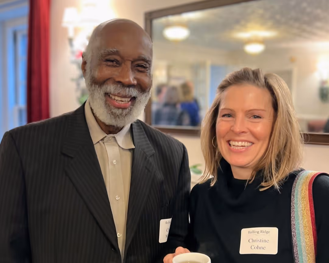 Two participants at a Rolling Ridge Christmas event smile for the camera
