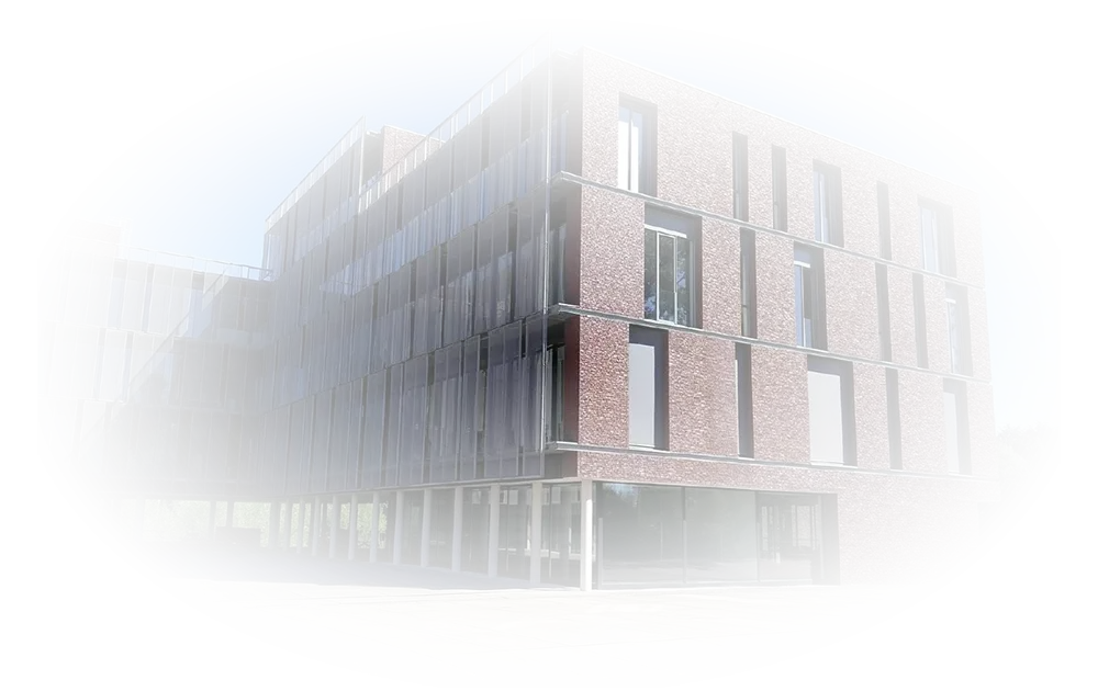 Modern office building with brick facade, large vertical windows, and glass panels on the left side under a clear blue sky.