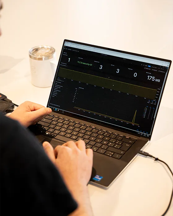 Photo taken over the shoulder of mateo, zoomed in on his laptop screen displaying a dashboard.