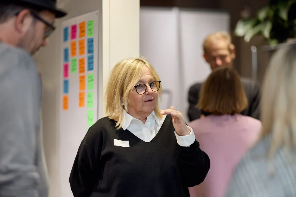 Eine Frau spricht zu einem Mann und einer Frau.