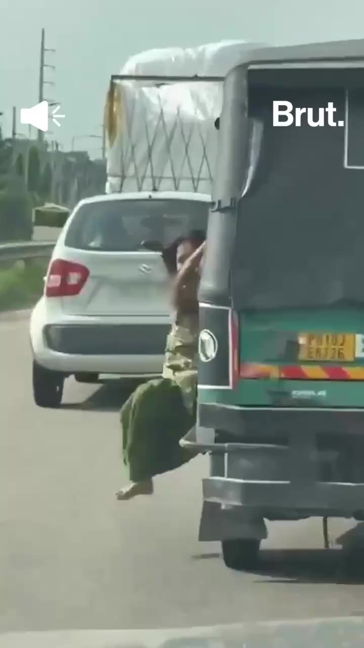 Why was this woman hanging from an auto?