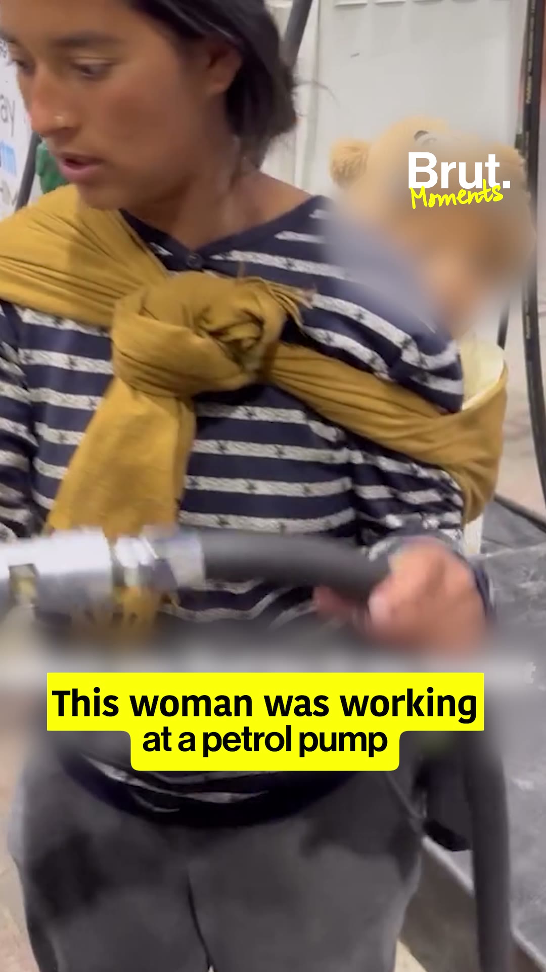 Mother working with her child strapped to her back