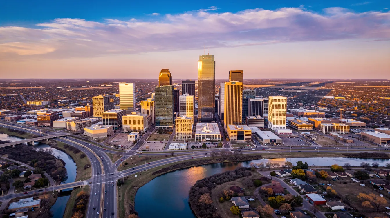 An aerial view of the Fort Worth, Texas skyline at sunset showcases tall buildings reflecting warm hues of orange and gold, creating a picturesque cityscape. This vibrant scene highlights the charm of Fort Worth homes and the thriving TX real estate market.