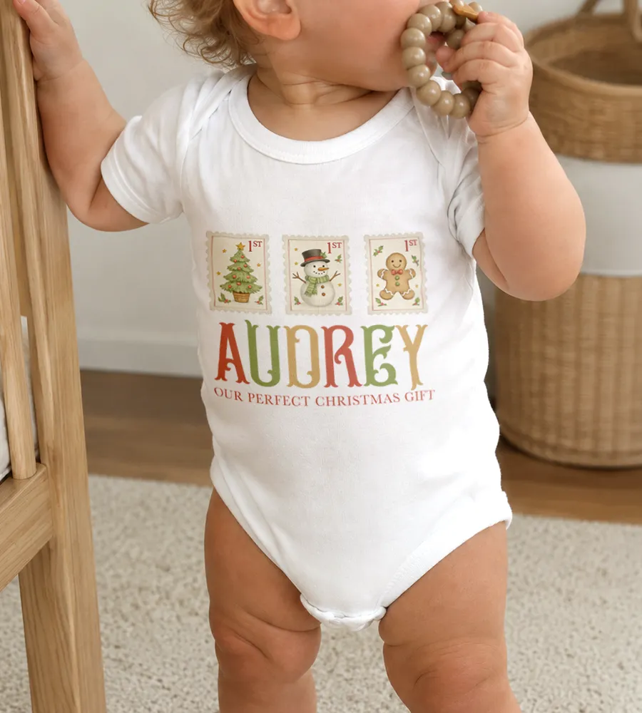 Baby wearing a personalized Christmas onesie with a custom name and festive illustrated design.